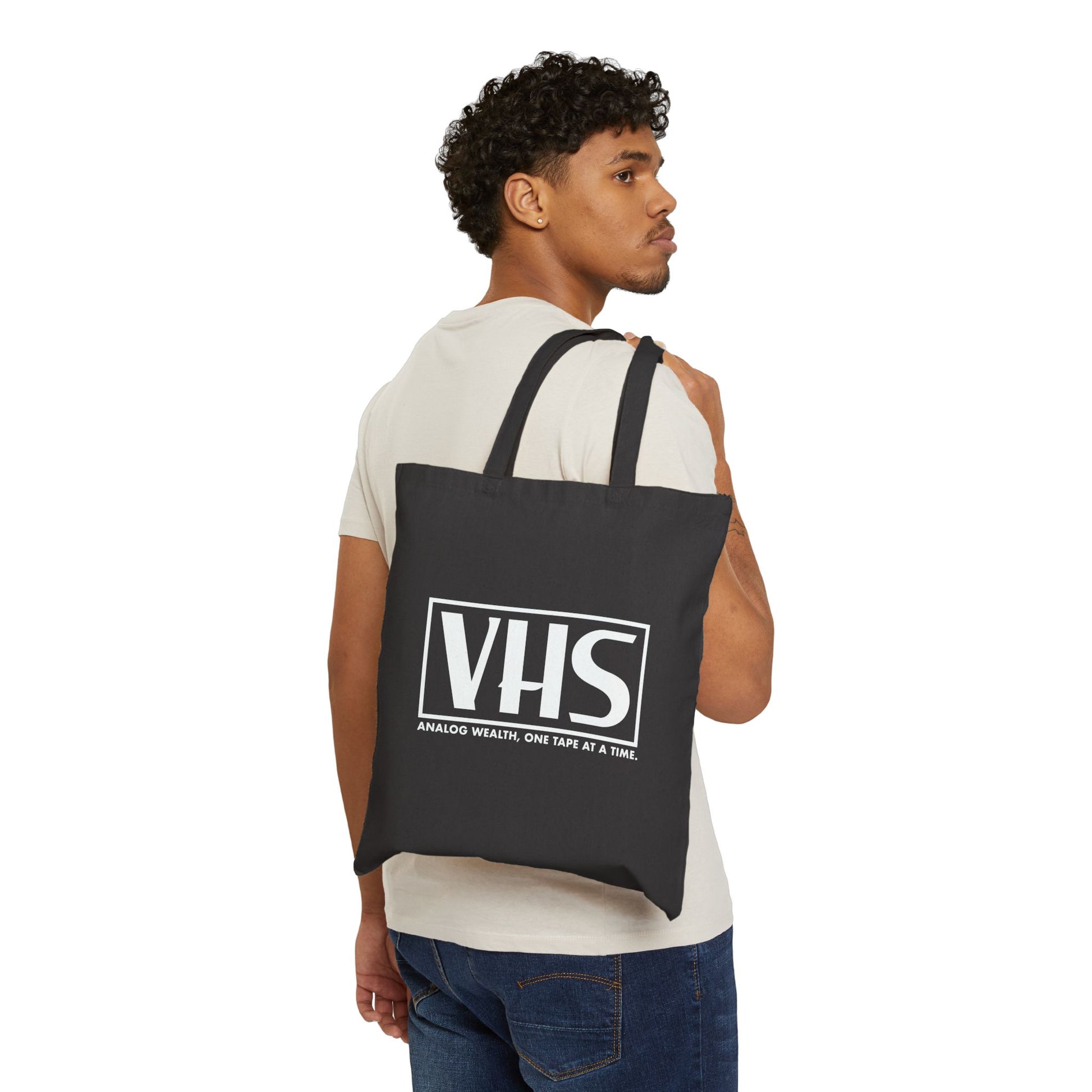 black tote bag featuring VHS analog wealth design in white