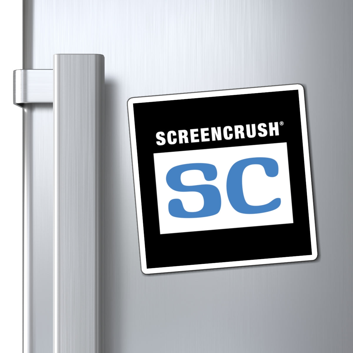 Black magnet outlined in white with white box containing blue SC rating shown on fridge